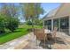 Outdoor seating on a stone paver patio perfect for enjoying the beautiful backyard at 203 Prestwick Dr, New Smyrna Beach, FL 32168