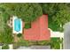An aerial view highlighting the red roof of a home, backyard pool, and mature landscaping at 222 Yarmouth Rd, Fern Park, FL 32730