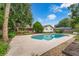 Serene backyard with a pool, patio, lush landscaping, and mature trees at 222 Yarmouth Rd, Fern Park, FL 32730