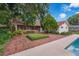 Inviting backyard with brick patio, lush greenery, and a glimpse of the sparkling pool at 222 Yarmouth Rd, Fern Park, FL 32730
