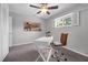 Bedroom featuring a ceiling fan, plush carpet, and a bright window with a white writing desk at 222 Yarmouth Rd, Fern Park, FL 32730