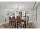 Traditional dining room featuring a dark wood table, elegant chandelier, and access to other living spaces at 222 Yarmouth Rd, Fern Park, FL 32730