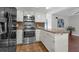 Well-appointed kitchen with stainless steel appliances and a seamless flow to the living area at 222 Yarmouth Rd, Fern Park, FL 32730