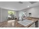 Bright kitchen featuring a bar top with double sink and access to outside at 222 Yarmouth Rd, Fern Park, FL 32730