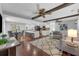 Spacious living room with dark wood-look floors, ceiling fans, and an open floor plan to the kitchen at 222 Yarmouth Rd, Fern Park, FL 32730