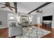 Inviting living room with ceiling beams, a decorative rug, and comfortable seating for relaxing and entertaining at 222 Yarmouth Rd, Fern Park, FL 32730
