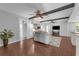 Open-concept living room showcasing ceiling beams, a decorative rug, and seamless flow to the kitchen at 222 Yarmouth Rd, Fern Park, FL 32730