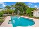 Sparkling pool surrounded by lush greenery and mature trees, perfect for relaxation at 222 Yarmouth Rd, Fern Park, FL 32730