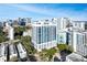 Stunning aerial view of a modern high-rise building in a bustling city with blue skies and mature landscaping at 260 Osceola Ave # 902, Orlando, FL 32801