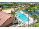 Aerial view of the community pool and surrounding area with lake at 4103 Tropical Isle Blvd # 132, Kissimmee, FL 34741