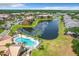 Stunning aerial view of the community with a lake and mature palm trees at 4103 Tropical Isle Blvd # 132, Kissimmee, FL 34741