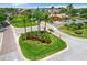 Community entrance sign surrounded by lush landscaping and mature palm trees at 4103 Tropical Isle Blvd # 132, Kissimmee, FL 34741