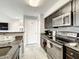 Well-equipped kitchen with stainless steel appliances, dark cabinets, and a convenient breakfast bar at 4103 Tropical Isle Blvd # 132, Kissimmee, FL 34741