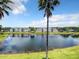 Scenic view of community lake, showcasing the surrounding residential buildings and lush landscape at 4103 Tropical Isle Blvd # 132, Kissimmee, FL 34741