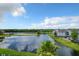 Scenic view of community lake, surrounded by residential buildings and lush landscape at 4103 Tropical Isle Blvd # 132, Kissimmee, FL 34741