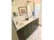 Elegant bathroom boasts double sinks, neutral decor and a tiled shower at 750 Hempstead Ave, Orlando, FL 32803