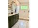 Stylish bathroom featuring a double vanity, tiled shower, and natural light at 750 Hempstead Ave, Orlando, FL 32803