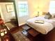 Well-lit bedroom features hardwood floors, a soft color scheme, and stylish decor at 750 Hempstead Ave, Orlando, FL 32803