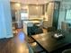 Open-concept kitchen with stainless steel appliances and an island with counter seating at 750 Hempstead Ave, Orlando, FL 32803