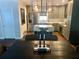 Modern kitchen with stainless steel appliances, an island with seating, and wood floors at 750 Hempstead Ave, Orlando, FL 32803
