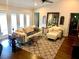 Bright living room boasts French doors, neutral walls, and a large area rug at 750 Hempstead Ave, Orlando, FL 32803