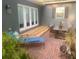 Relaxing brick patio featuring outdoor furniture, beautiful plants and a set of glass paneled French doors at 750 Hempstead Ave, Orlando, FL 32803