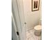 Toilet room features a white toilet, white door and trim, neutral wall color, and marble-look tile at 750 Hempstead Ave, Orlando, FL 32803