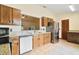 Well-lit kitchen features wooden cabinets and stainless steel appliances at 1037 Parnell Ct, Deltona, FL 32738