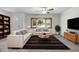 Inviting living room with large window, ceiling fan, comfortable seating, and stylish decor at 1212 Russell Dr, Ocoee, FL 34761