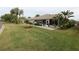 Expansive backyard with a screened lanai, beautiful landscaping, and serene outdoor living space at 1669 Plum Branch Ter, The Villages, FL 32162