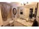 Bathroom with shower and tub combo, marble counters, and decorative hardware at 1669 Plum Branch Ter, The Villages, FL 32162