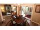 Elegant dining room with a classic table setting and views of the outdoor living area at 1669 Plum Branch Ter, The Villages, FL 32162