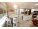 Eat-in kitchen with stainless appliances, custom island, granite countertops and stylish lighting at 1669 Plum Branch Ter, The Villages, FL 32162