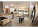 Well-appointed kitchen with granite countertops, a center island, and modern appliances at 1669 Plum Branch Ter, The Villages, FL 32162