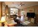 Cozy living room with comfortable seating, a ceiling fan, and plenty of natural light at 1669 Plum Branch Ter, The Villages, FL 32162