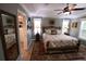 Primary bedroom with plush bed, en suite bath, vintage rug, and ample natural light at 1669 Plum Branch Ter, The Villages, FL 32162