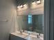 Bright bathroom featuring a double vanity with modern fixtures, a large mirror, and a well-lit space at 2451 W 18Th St, Sanford, FL 32771