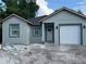 Charming single-story home featuring a gray exterior with a one-car garage and a well-maintained front yard at 2451 W 18Th St, Sanford, FL 32771