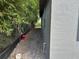 Side view of a gray house with a fence and green foliage at 2451 W 18Th St, Sanford, FL 32771