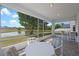 Relaxing screened-in porch with a scenic water view and outdoor seating, perfect for enjoying the peaceful surroundings at 408 Lexingdale Dr, Orlando, FL 32828