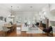 Bright open concept living area featuring hardwood floors, fireplace, and double doors to the yard at 452 Raccoon St, Lake Mary, FL 32746