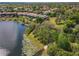 Beautiful aerial view of a large lakefront home with private boat docks and mature trees overlooking the lake at 7808 The Esplanade Ct, Orlando, FL 32836