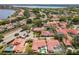 Picture perfect aerial view of a neighborhood showcasing the pools, red roofs, green trees, and well manicured lawns at 7808 The Esplanade Ct, Orlando, FL 32836