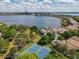 Wonderful aerial view overlooking the tennis courts and lake with beautiful homes and lush trees surrounding the area at 7808 The Esplanade Ct, Orlando, FL 32836
