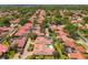 Nice aerial view of the neighborhood, showcasing the red roofs, green trees, and well-manicured lawns at 7808 The Esplanade Ct, Orlando, FL 32836
