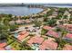 Stunning aerial shot showcases the beautiful homes near the lake, red roofs, pools, and wonderful landscaping at 7808 The Esplanade Ct, Orlando, FL 32836