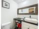Modern bathroom with a vessel sink, wood-trimmed mirror, and stylish fixtures at 7808 The Esplanade Ct, Orlando, FL 32836