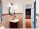 Bathroom featuring tiled walls, stylish vanity with round mirror, and doorway view into an office area at 7808 The Esplanade Ct, Orlando, FL 32836