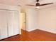 Bedroom with hardwood floors, closet space, and neutral walls creates a cozy atmosphere at 7808 The Esplanade Ct, Orlando, FL 32836