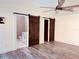 Bedroom featuring ceiling fan, barn doors, and bathroom access at 7808 The Esplanade Ct, Orlando, FL 32836